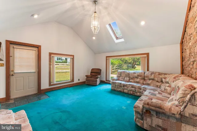 a living room with furniture and a floor to ceiling window