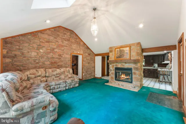 a living room with couches and dining table with wooden floor