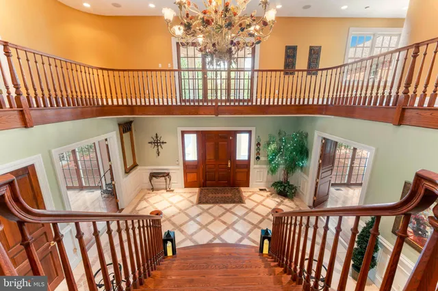 a view of a dining room with furniture a chandelier and wooden floor