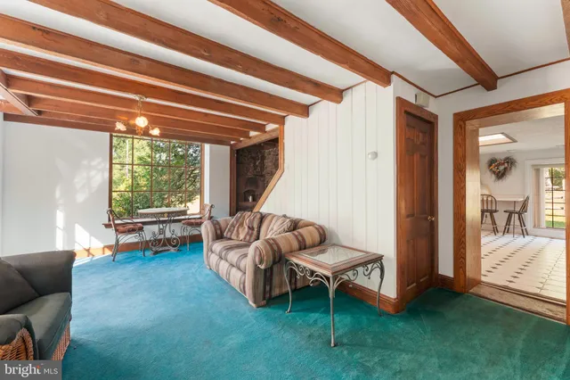 a view of a room with window and a ceiling fan
