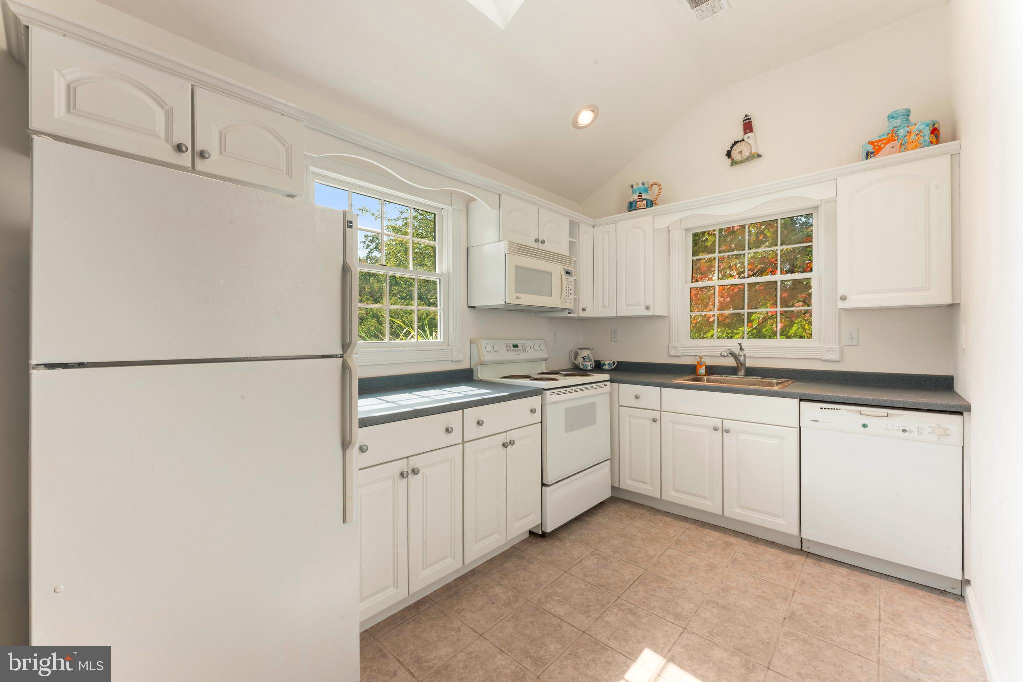 1390 Old Jacksonville Road Ivyland, PA 18974 - Photo 72 of 75 a kitchen with granite countertop white cabinets and white appliances