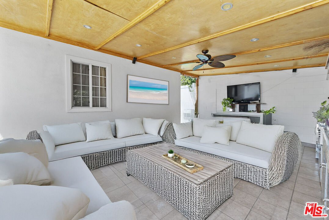 1430 North Dominion Avenue Pasadena, CA 91104 - Photo 12 of 25 a living room with furniture a flat screen tv and a table