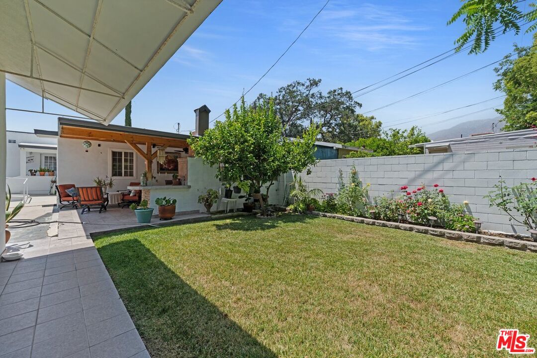 1430 North Dominion Avenue Pasadena, CA 91104 - Photo 13 of 25 a view of a patio with table and chairs potted plants and large tree