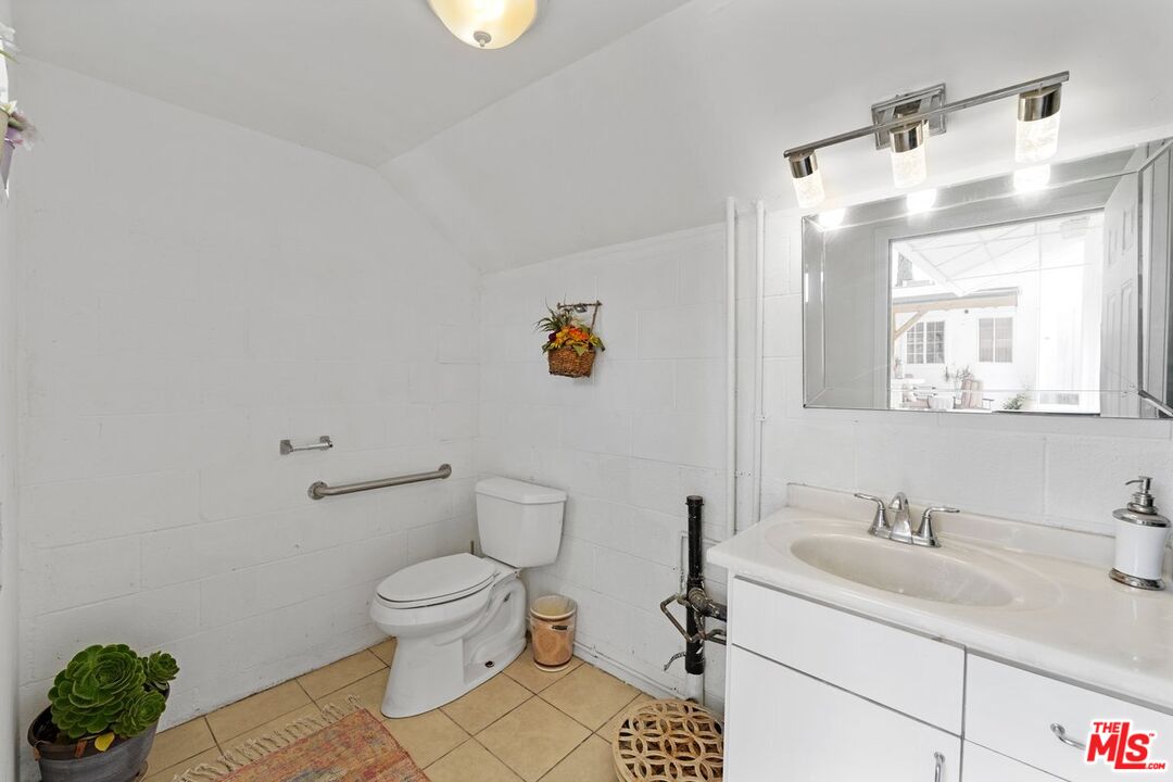 1430 North Dominion Avenue Pasadena, CA 91104 - Photo 14 of 25 a bathroom with a sink toilet and mirror