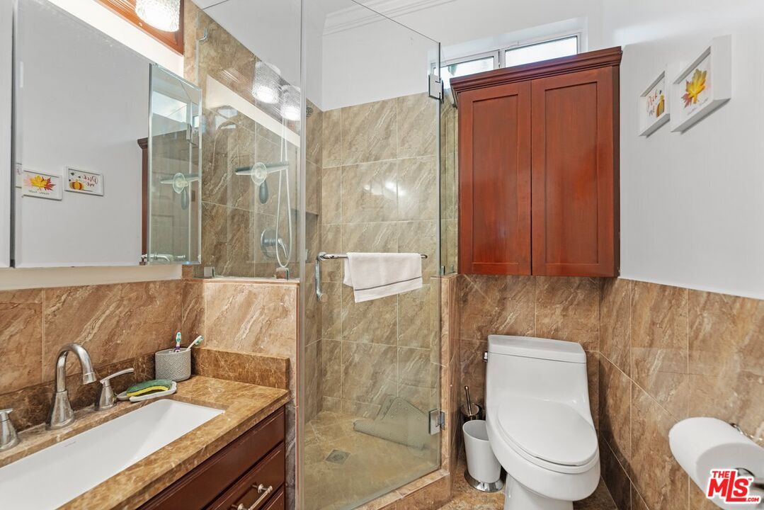 1430 North Dominion Avenue Pasadena, CA 91104 - Photo 19 of 25 a bathroom with a sink a toilet and shower