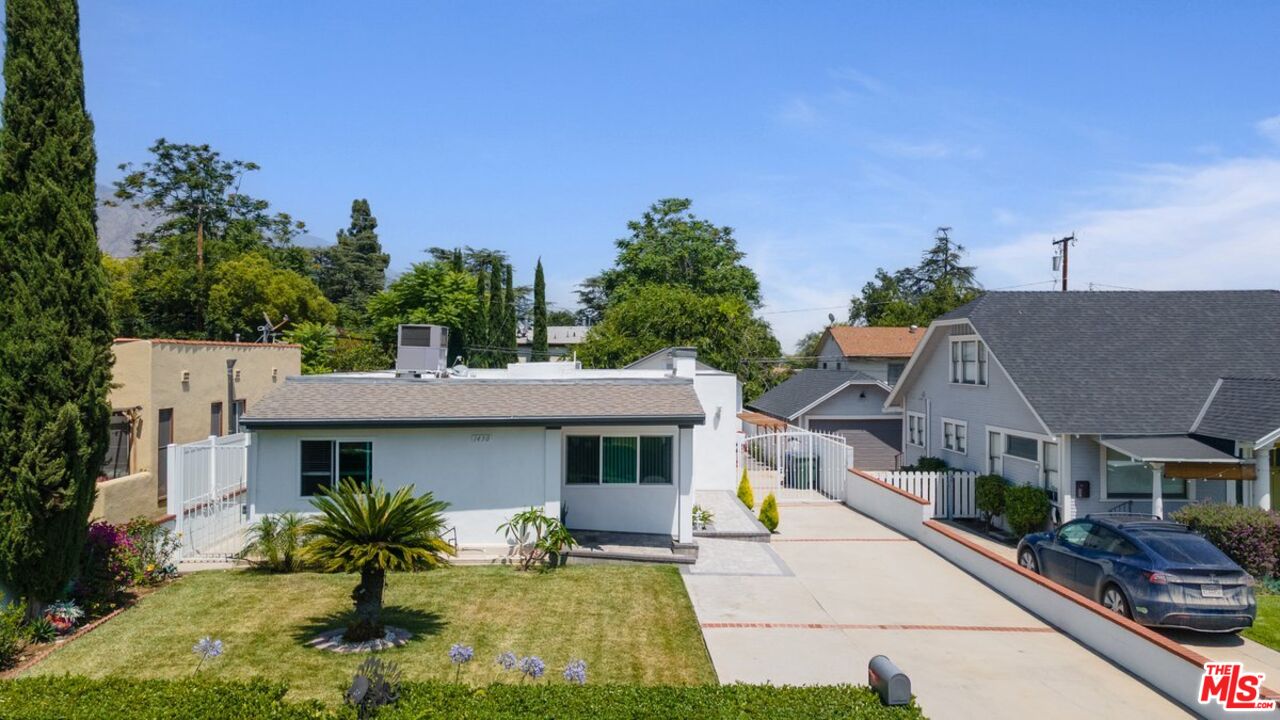 1430 North Dominion Avenue Pasadena, CA 91104 - Photo 6 of 25 a front view of a house with a yard and potted plants