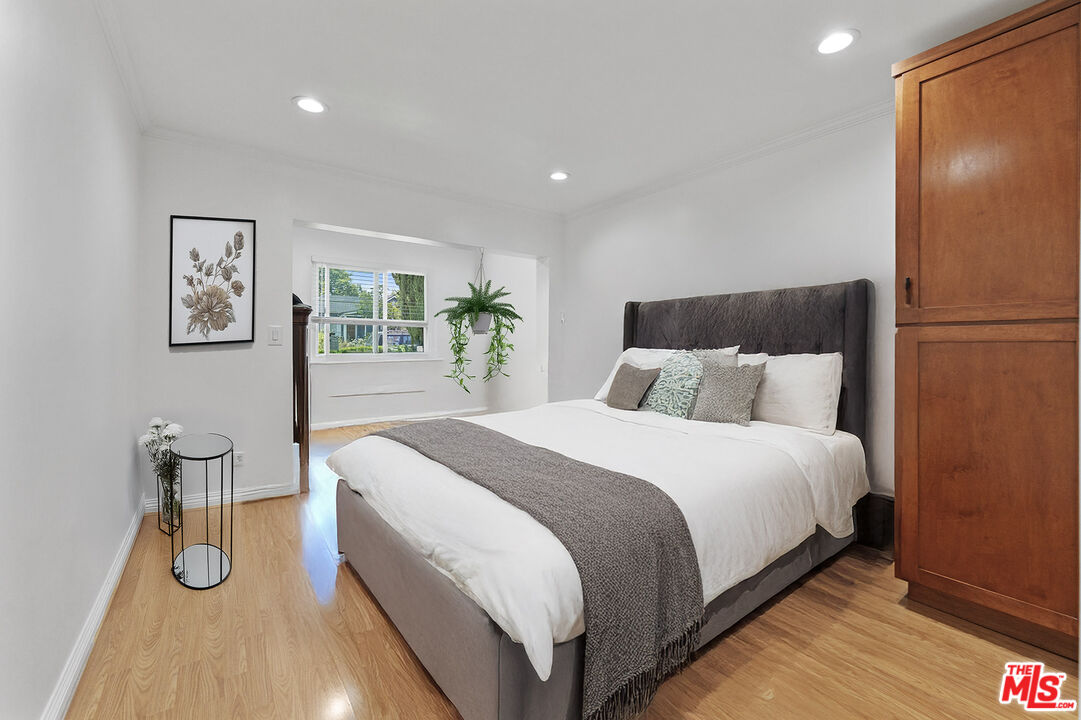 1430 North Dominion Avenue Pasadena, CA 91104 - Photo 9 of 25 a bedroom with a bed and painting on the wall