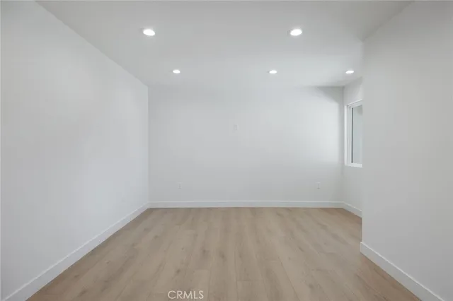 a view of room with wooden floor and window