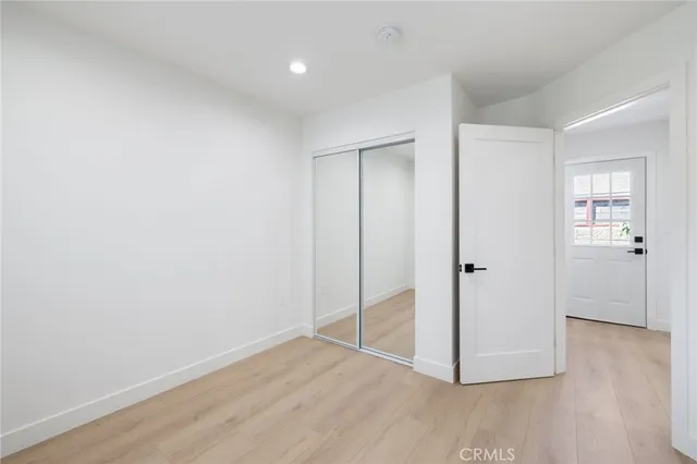 a view of an empty room and wooden floor