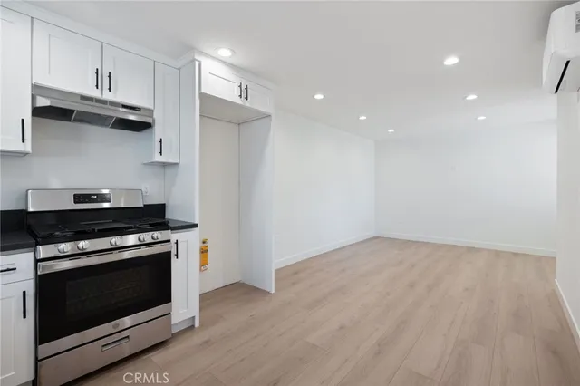 a kitchen with stainless steel appliances a stove and a microwave