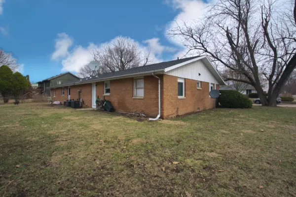 a front view of house with backyard and tree