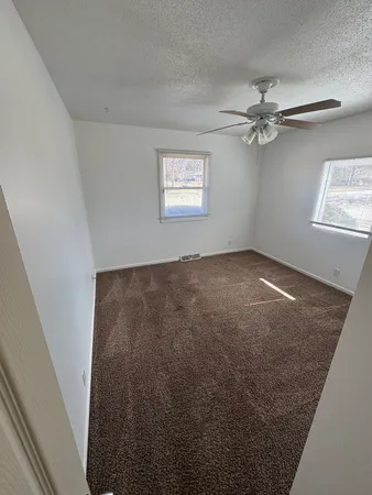 a bathroom with a double vanity sink toilet and mirror