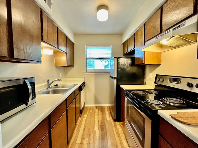 a kitchen that has a sink and a stove