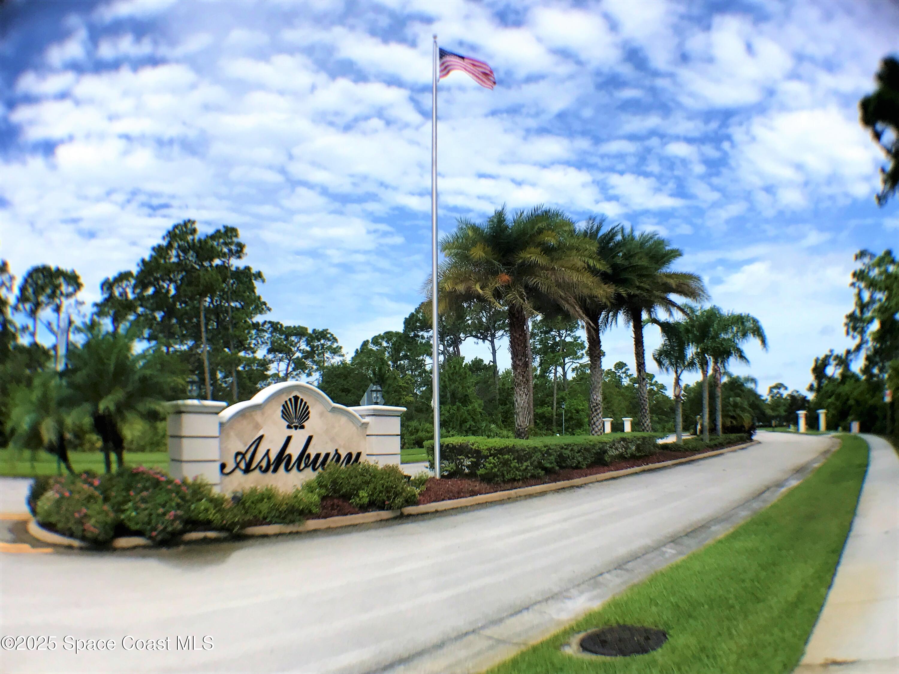 a front view of a house with a yard and potted plants