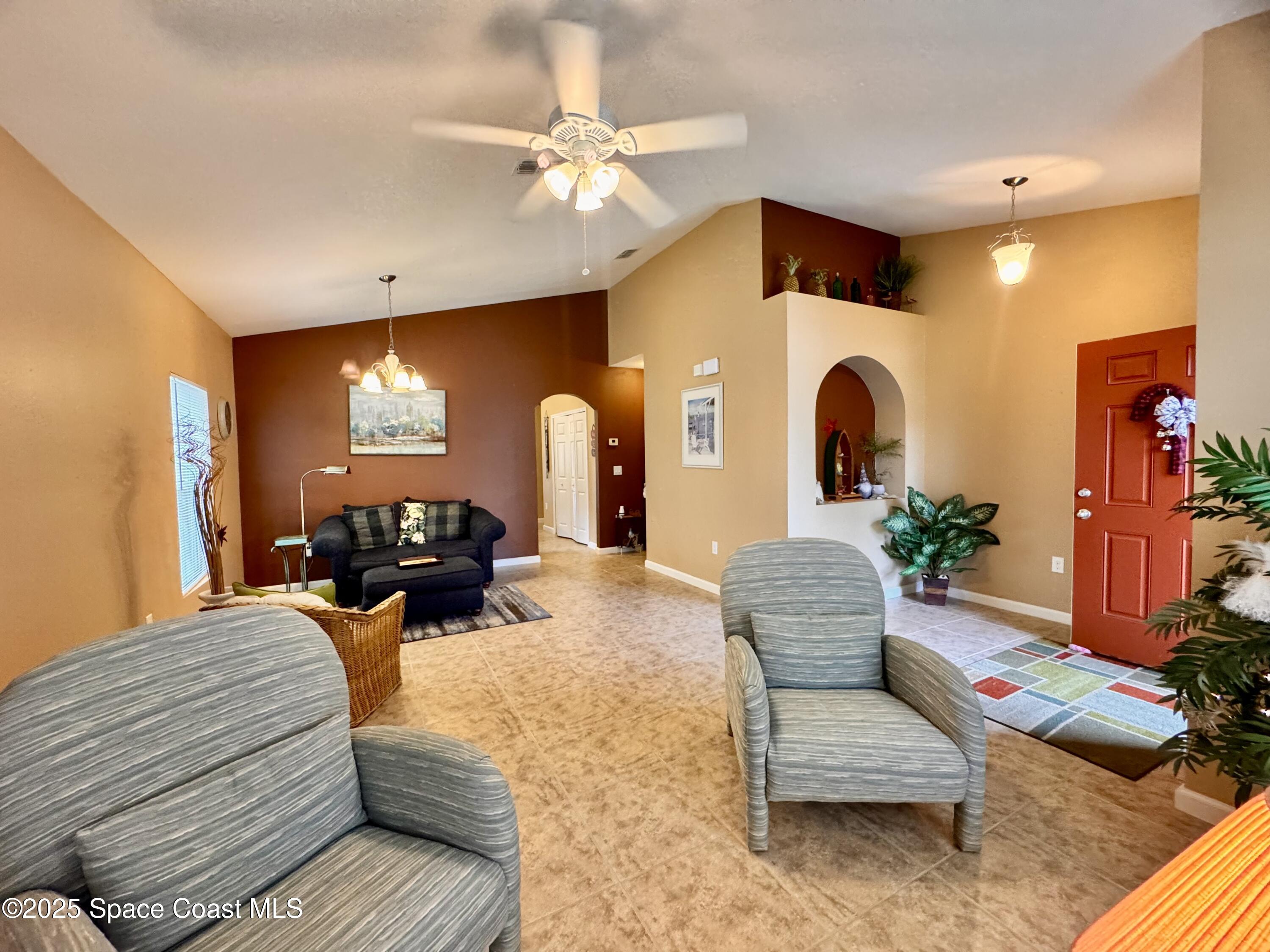 217 Briarcliff Circle Sebastian, FL 32958 - Photo 20 of 36 a living room with furniture and a chandelier