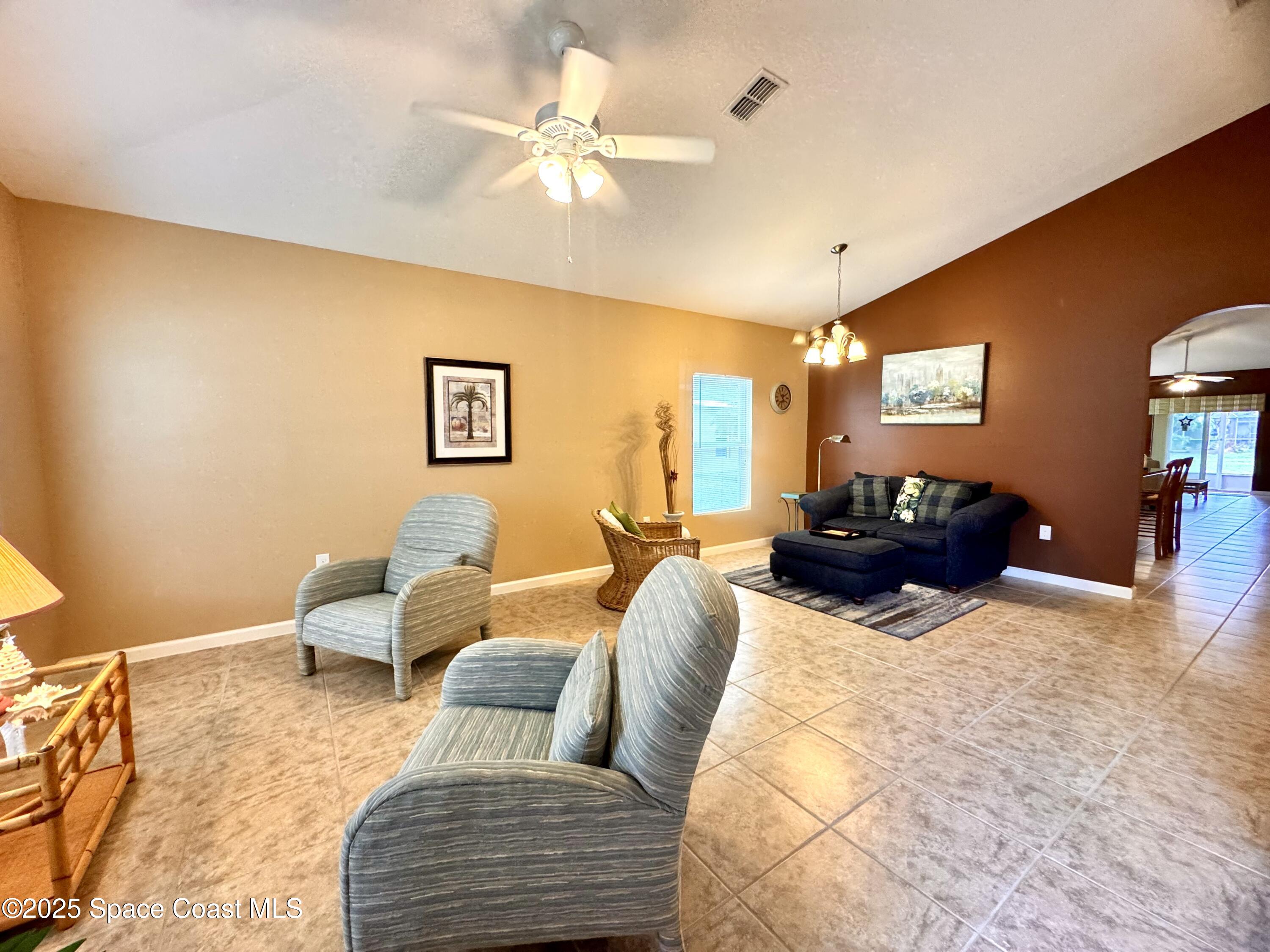 217 Briarcliff Circle Sebastian, FL 32958 - Photo 22 of 36 a living room with furniture and a chandelier