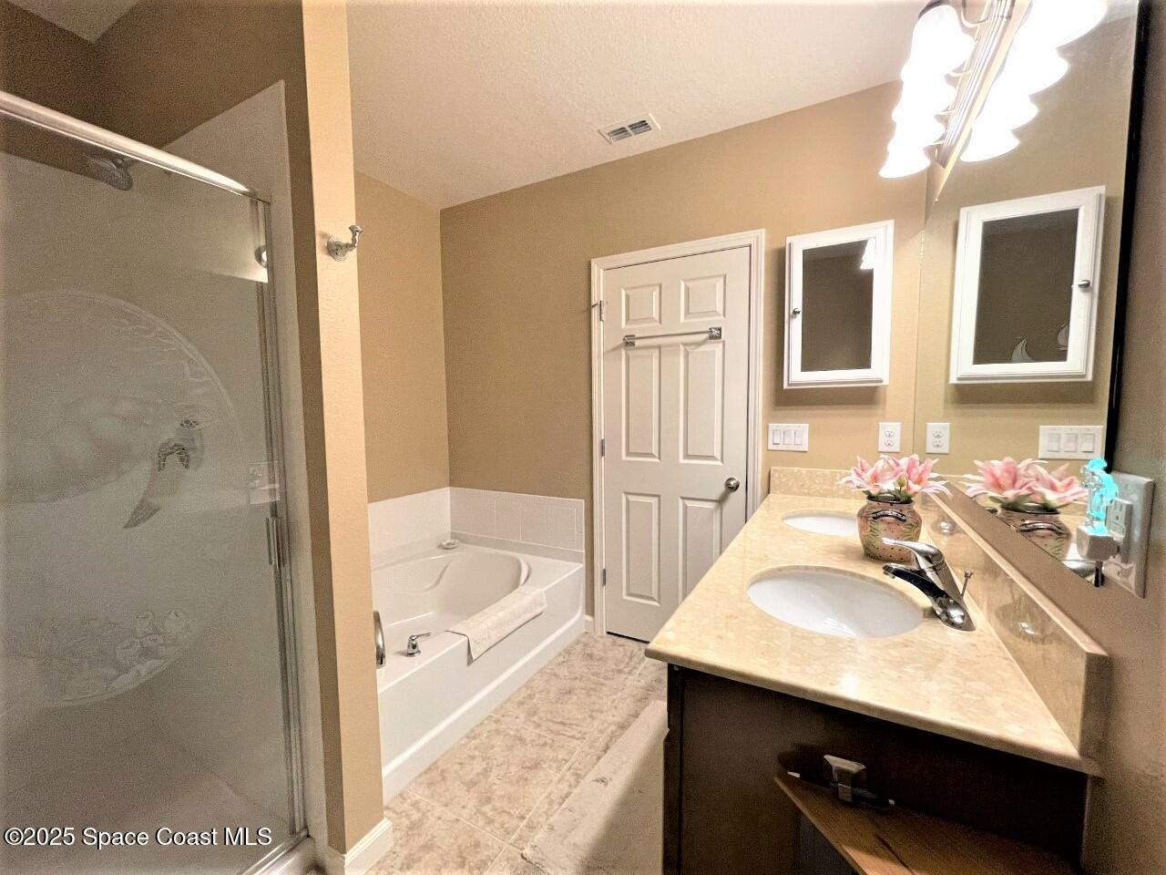 217 Briarcliff Circle Sebastian, FL 32958 - Photo 29 of 36 a bathroom with a granite countertop sink a bathtub a mirror and shower