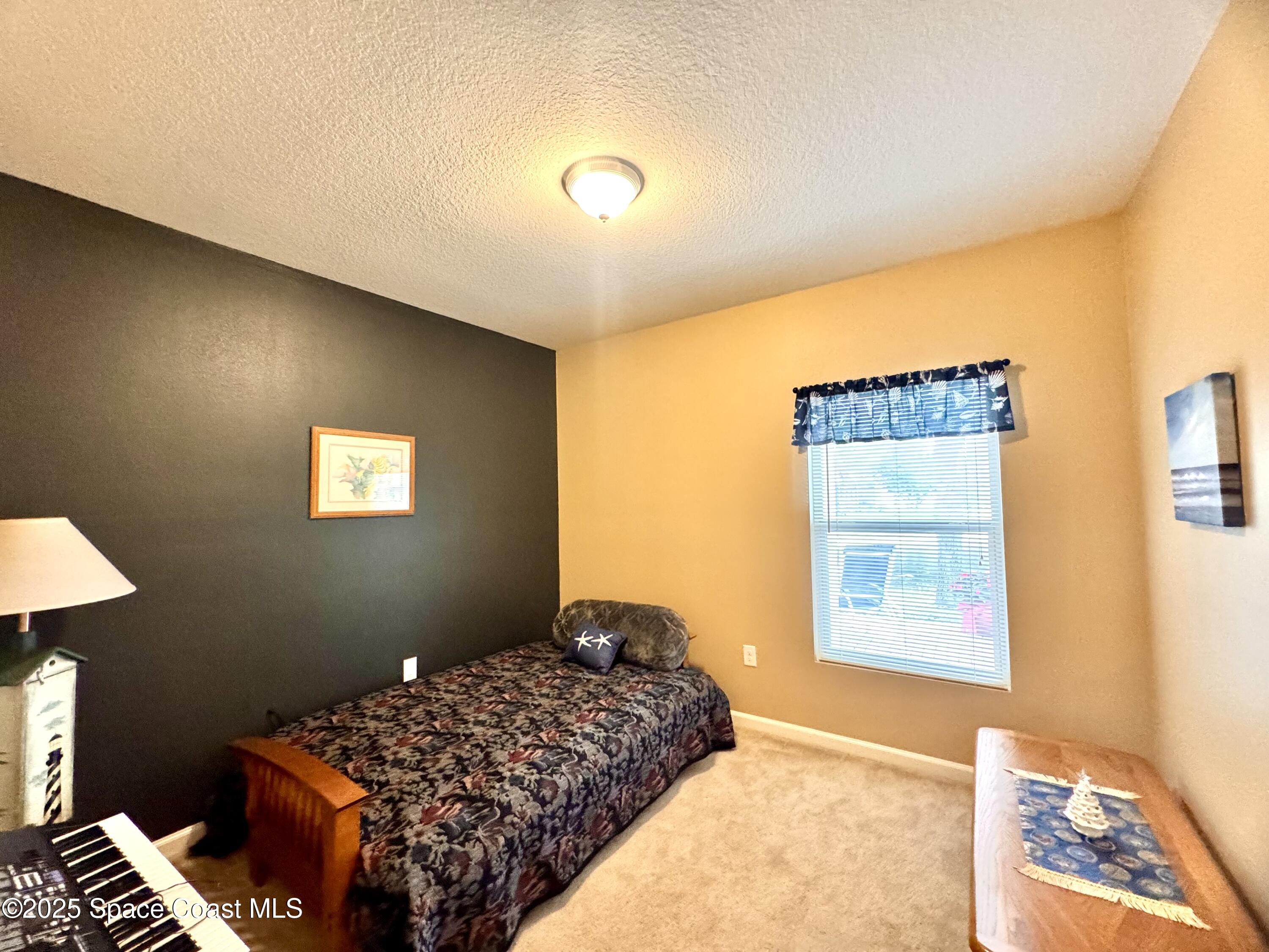 217 Briarcliff Circle Sebastian, FL 32958 - Photo 33 of 36 a bedroom with a bed and a window