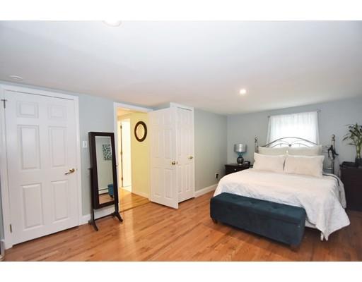 201 Cart Path Road Tewksbury, MA 01876 - Photo 18 of 29 a bedroom with a bed and wooden floor