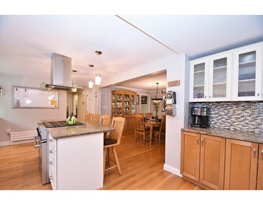 201 Cart Path Road Tewksbury, MA 01876 - Photo 4 of 29 a kitchen with stainless steel appliances kitchen island granite countertop a table chairs and a refrigerator