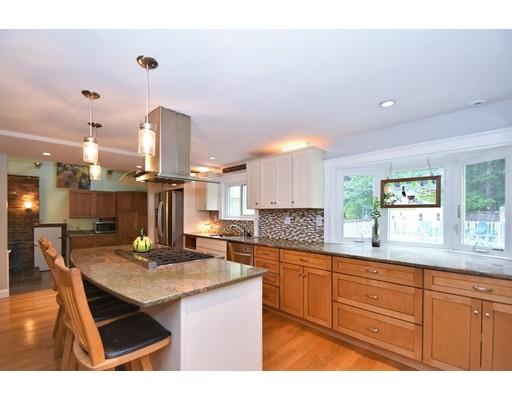 201 Cart Path Road Tewksbury, MA 01876 - Photo 5 of 29 a kitchen with stainless steel appliances granite countertop a sink dishwasher a stove a dining table and chairs with wooden floor