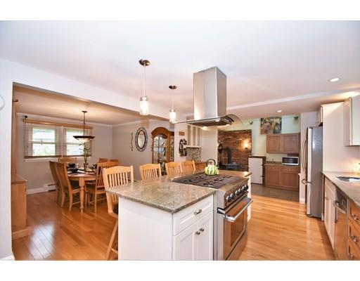 201 Cart Path Road Tewksbury, MA 01876 - Photo 6 of 29 a kitchen with stainless steel appliances granite countertop a table chairs and a refrigerator