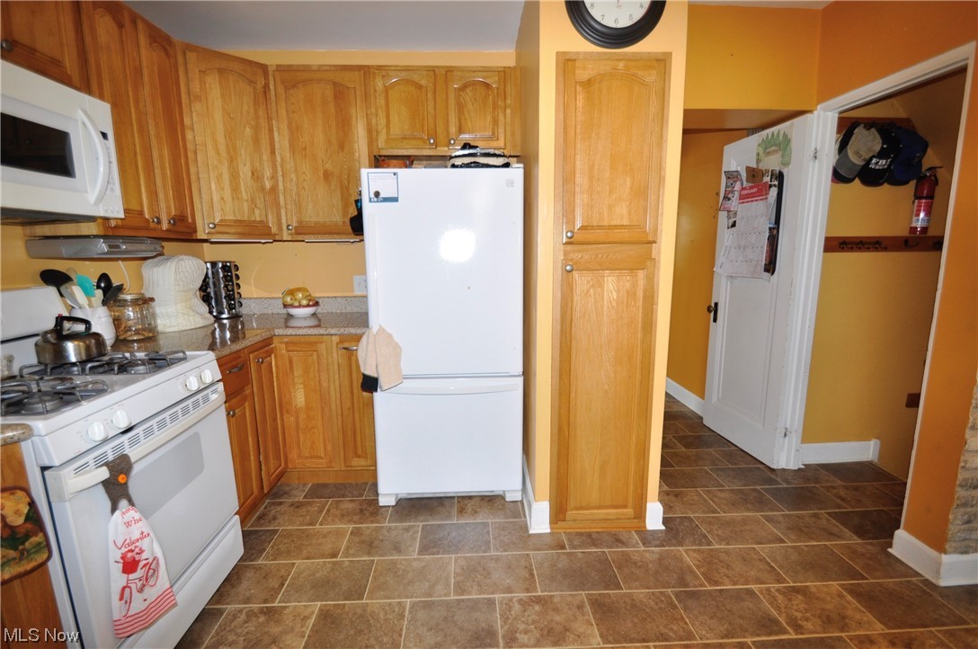 1899 West Pleasant Valley Road Parma, OH 44134 - Photo 17 of 47 Kitchen with white appliances and dark tile floors