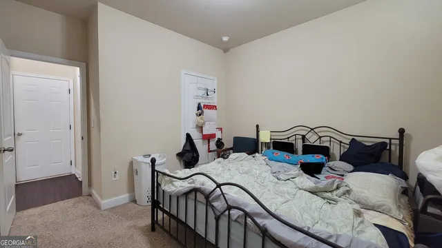 a bedroom with bed and a closet