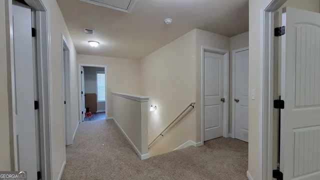 a view of a hallway with an entryway