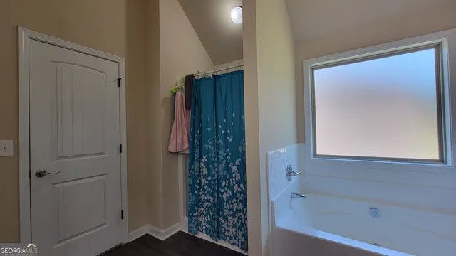 a bathroom with a granite countertop sink a toilet and a mirror