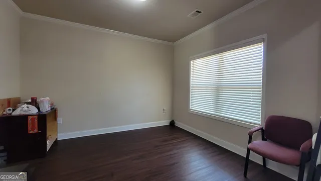 a view of a workspace with furniture and a window