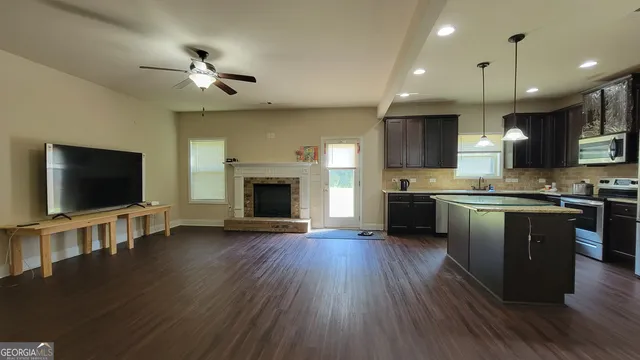 a view of kitchen with sink microwave and stove
