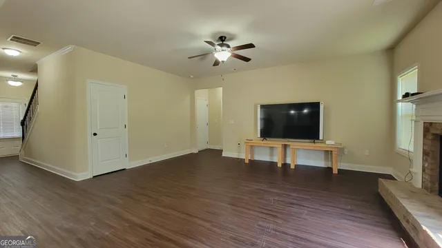 a view of a livingroom with furniture and a flat screen tv