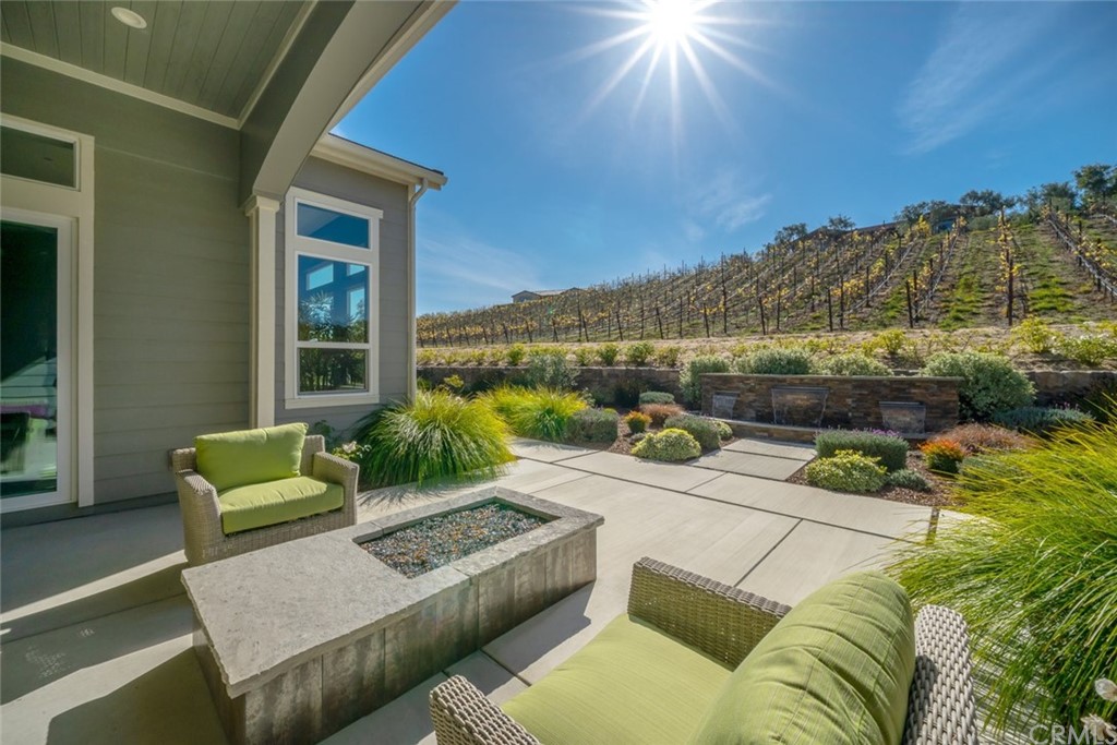 1481 Mesa Road Nipomo, CA 93444 - Photo 11 of 74 a view of a patio with couches chairs and a floor to ceiling window