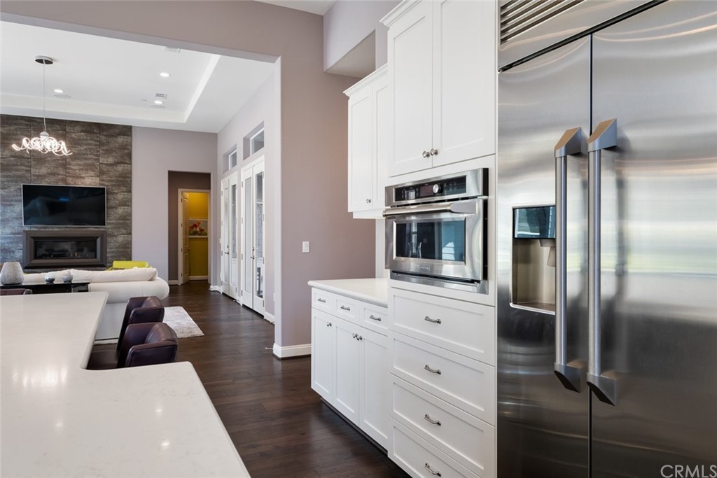 1481 Mesa Road Nipomo, CA 93444 - Photo 25 of 74 a living room with stainless steel appliances furniture a fireplace and a flat screen tv