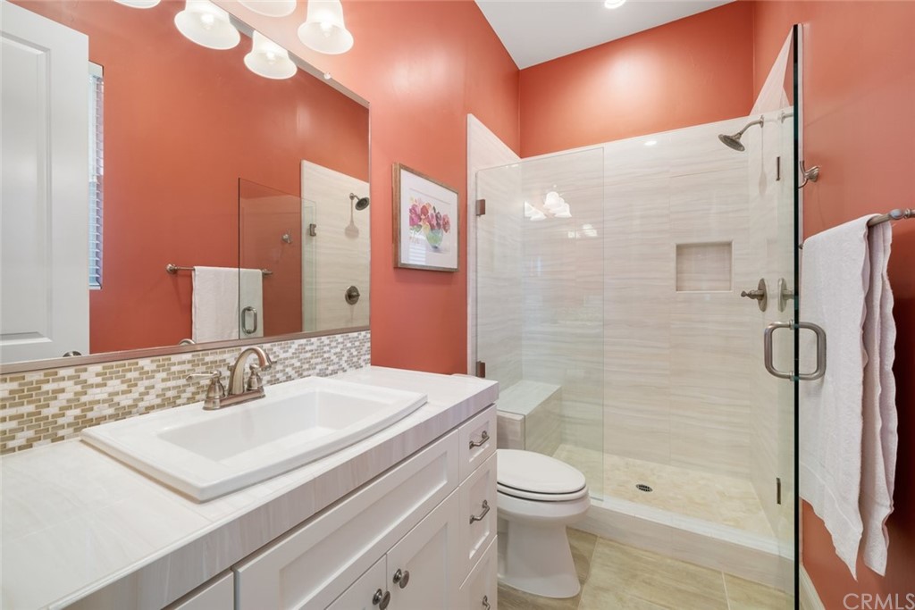 1481 Mesa Road Nipomo, CA 93444 - Photo 41 of 74 a bathroom with a sink a toilet a mirror and shower