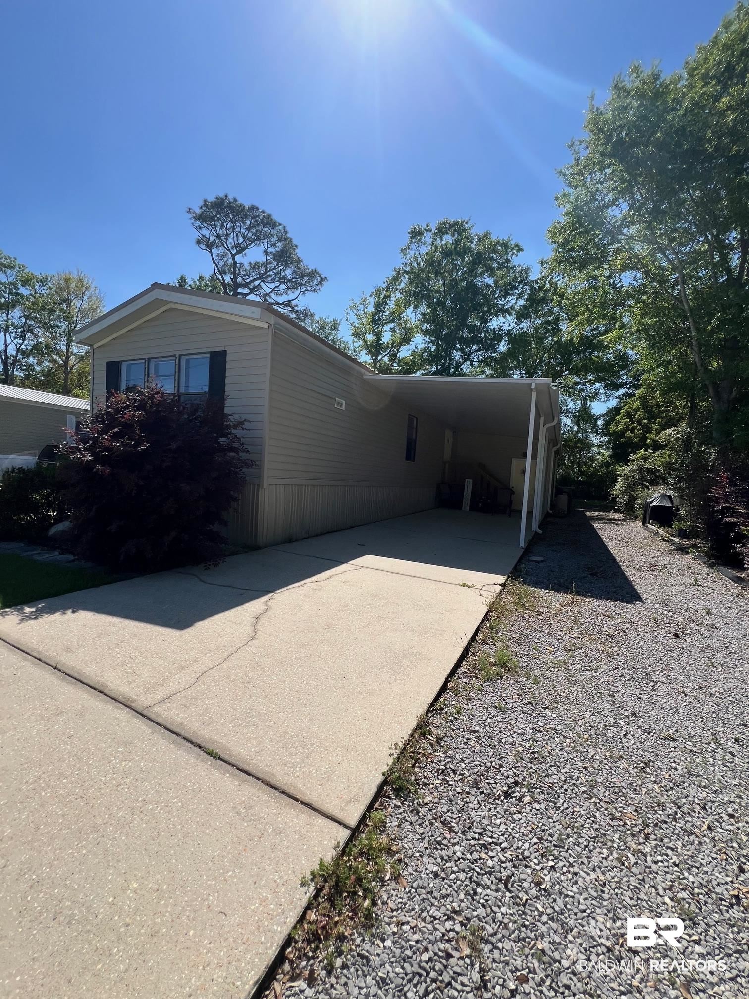 1936 Ridgewood Drive Lillian, AL 36549 - Photo 2 of 30 View of property exterior with driveway and a carport