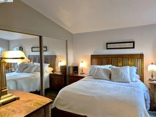 a bedroom with double bed and a lamp