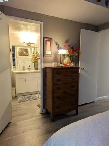 a room with a dresser and a window