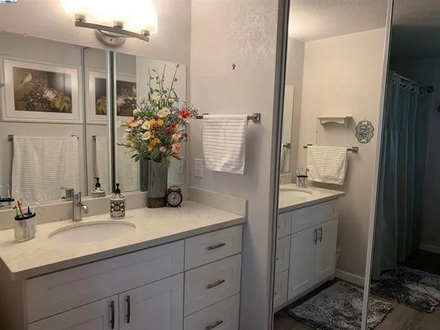 a bathroom with a sink double vanity and a mirror