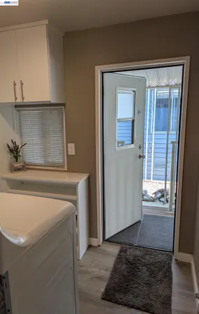a kitchen with white cabinets and white appliances