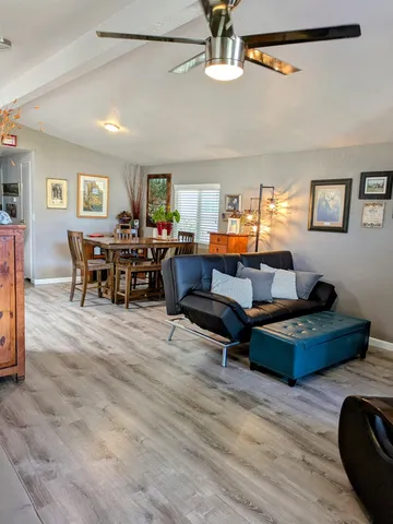 a living room with furniture and a wooden floor