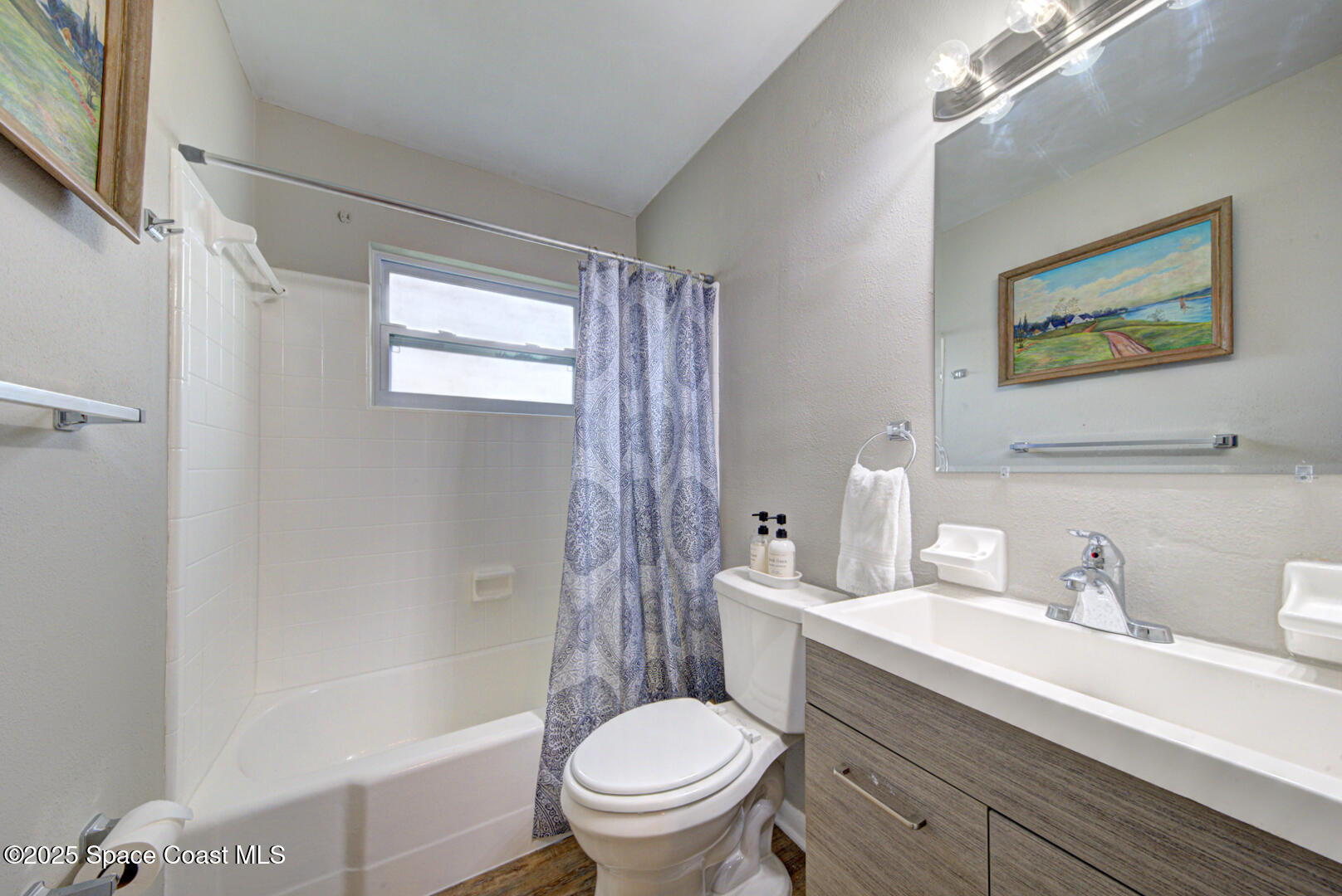 813 7th Street Merritt Island, FL 32953 - Photo 13 of 28 a bathroom with a toilet a sink and a bathtub