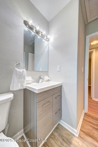 a bathroom with a sink vanity and a toilet