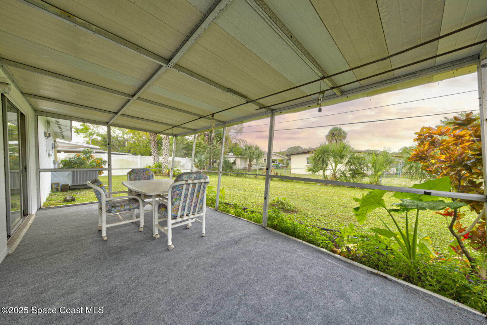 813 7th Street Merritt Island, FL 32953 - Photo 21 of 28 a view of a two chair in the patio next to a yard