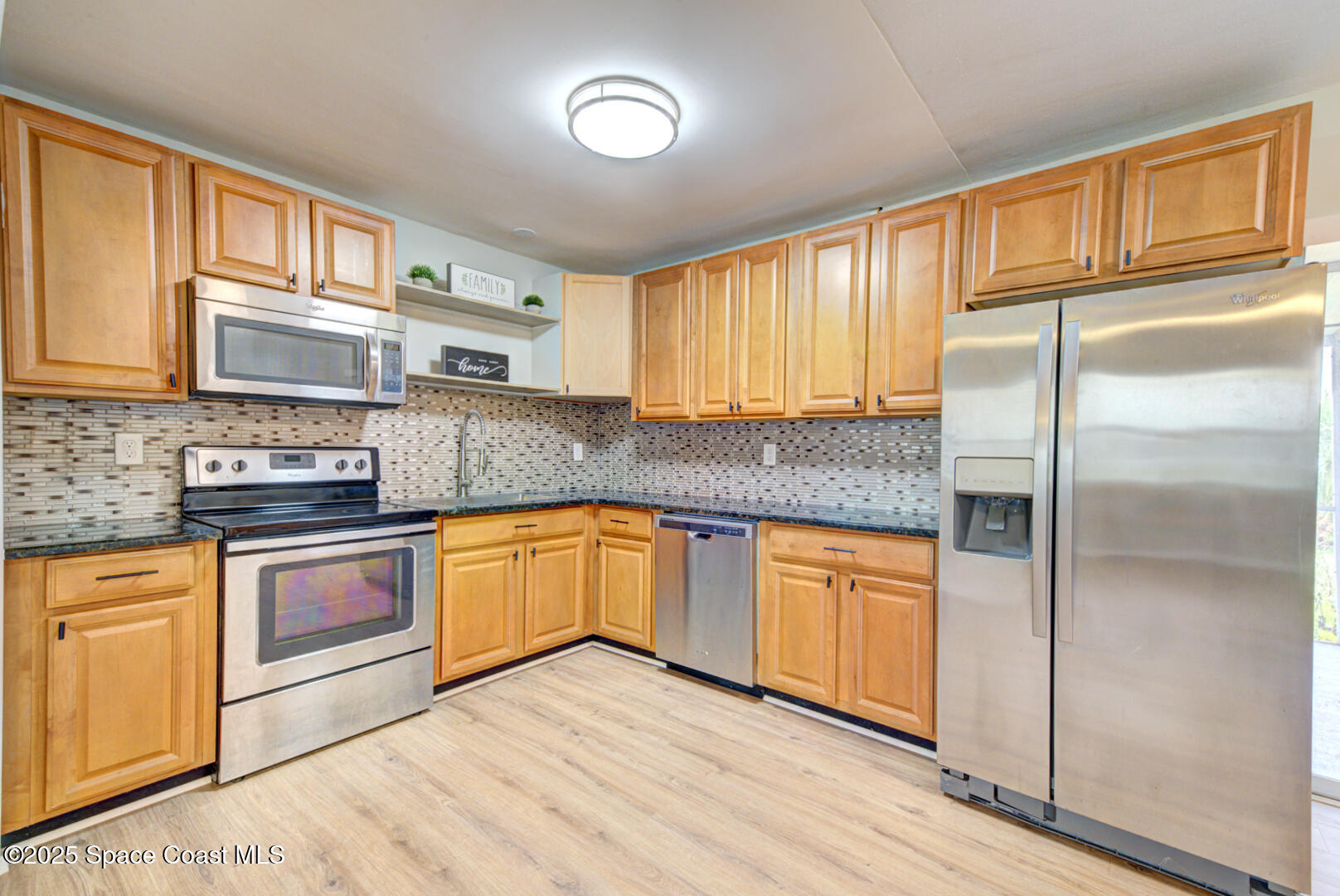 813 7th Street Merritt Island, FL 32953 - Photo 3 of 28 a kitchen with stainless steel appliances granite countertop a refrigerator sink and cabinets
