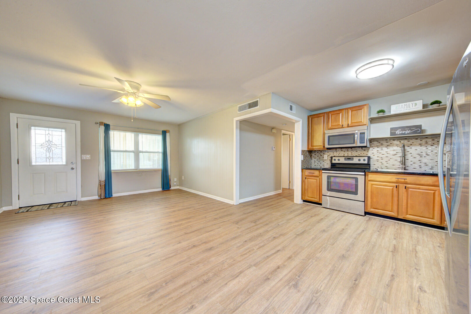 813 7th Street Merritt Island, FL 32953 - Photo 7 of 28 a view of kitchen with wooden floor electronic appliances and window