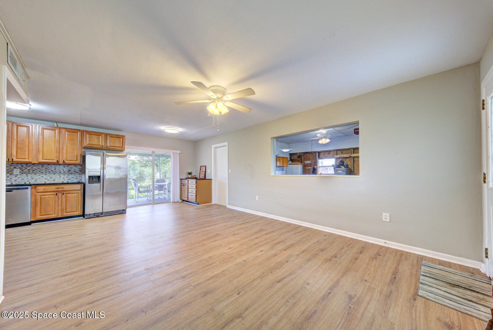 813 7th Street Merritt Island, FL 32953 - Photo 8 of 28 a view of an empty room with a window and wooden floor