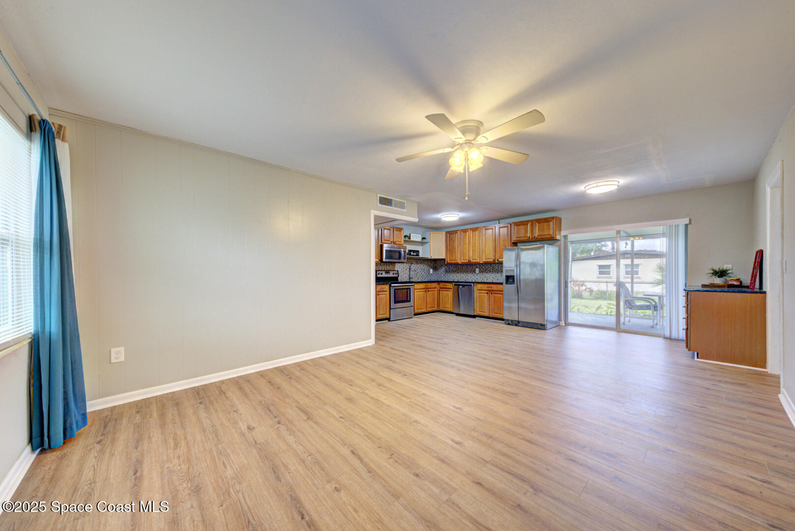 813 7th Street Merritt Island, FL 32953 - Photo 9 of 28 a view of an empty room with a window and wooden floor