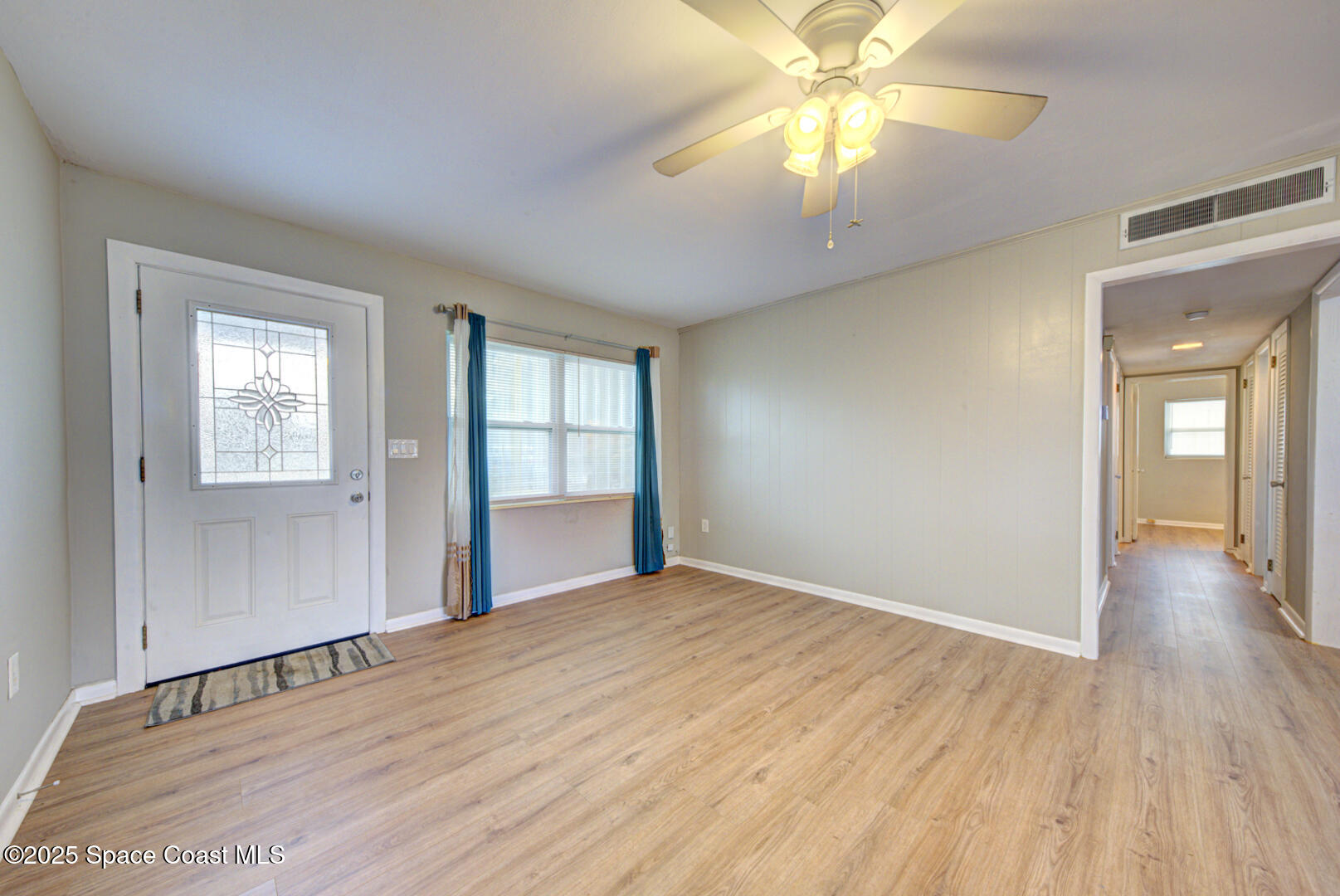 813 7th Street Merritt Island, FL 32953 - Photo 10 of 28 a view of an empty room with window and wooden floor